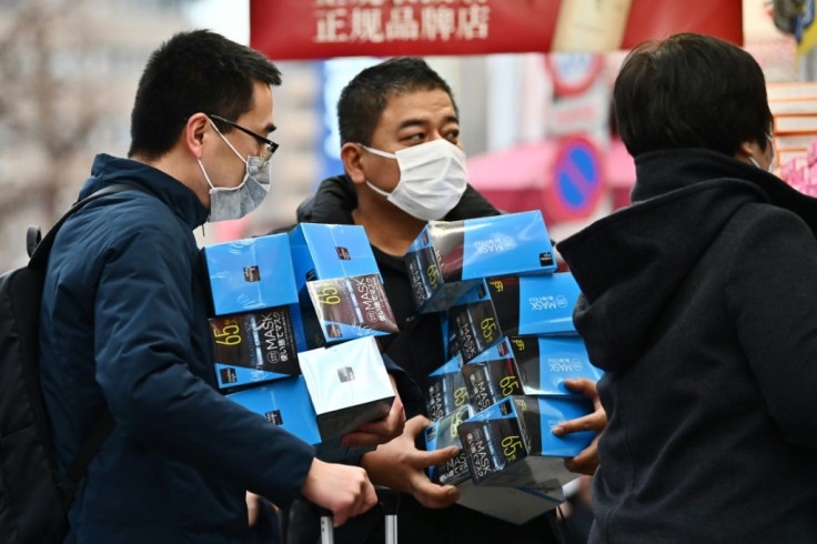 Customers bulk-buying face masks from a drugstore in Tokyo's Akihabara district