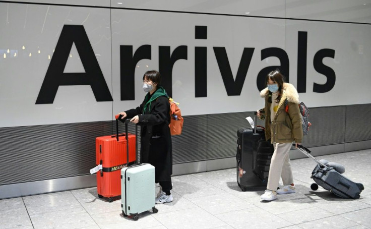 Passengers wear face masks after their flight arrived at Heathrow Airport in London