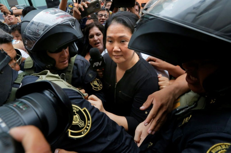 Keiko Fujimori arrives at a Lima courthouse surrounded by police