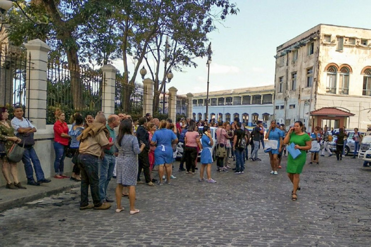 Workers leave their building after a quake is felt in Havana -- the 7.7 magnitude quake struck northwest of Jamaica on January 28, 2020