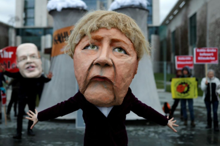 Outside Chancellor Angela Merkel's office, marchers brandished signs reading "Shut off the coal plants NOW"