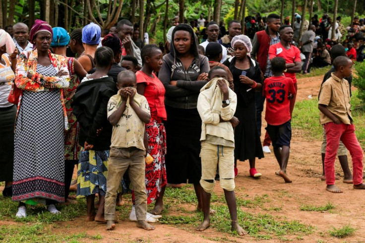Mourning: The scene in Oicha, in the Beni region, on November 29 after more than two dozen people were hacked to death