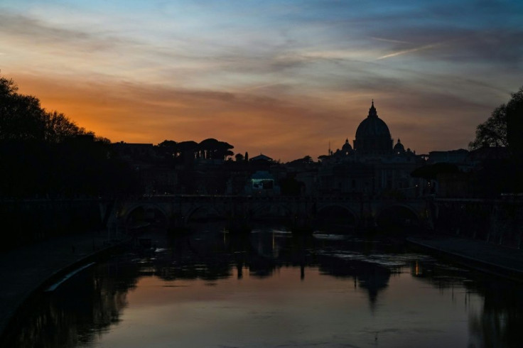 The sun sets over St Peter's Basilica (Rear R) at the Vatican, which abruptly shuttered a religious order whose members are under investigation for sexual assault