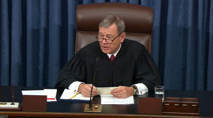 US Supreme Court Chief Justice John Roberts reads a question from a senator at President Donald Trump's impeachment trial