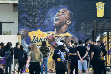 Fans gather to mourn the death of NBA legend Kobe Bryant at a mural near Staples Center