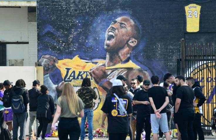 Fans gather to mourn the death of NBA legend Kobe Bryant at a mural near Staples Center
