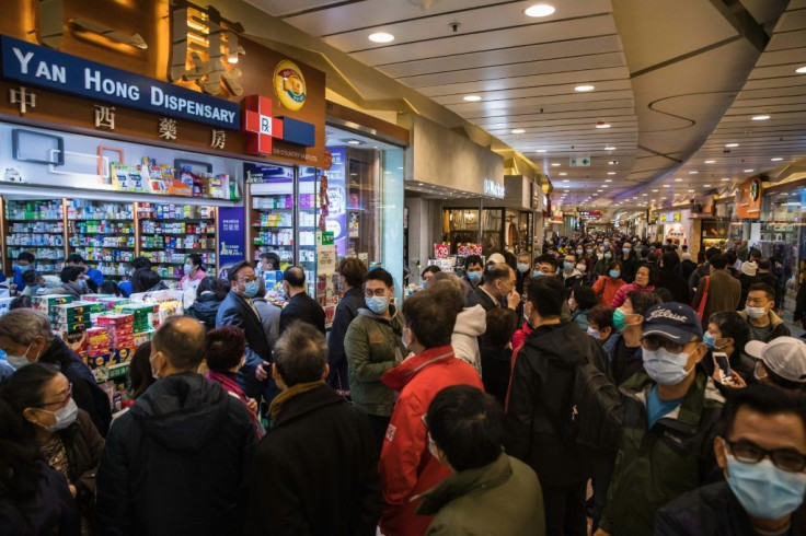 People queue outside outside a pharmacy selling masks in Hong Kong