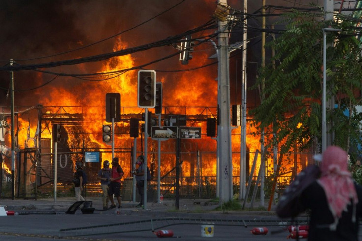 Protesters set a construction site on fire outside Santiago's Monumental stadium on January 29, 2020, after a fan of the Colo Colo team was run over by a police truck