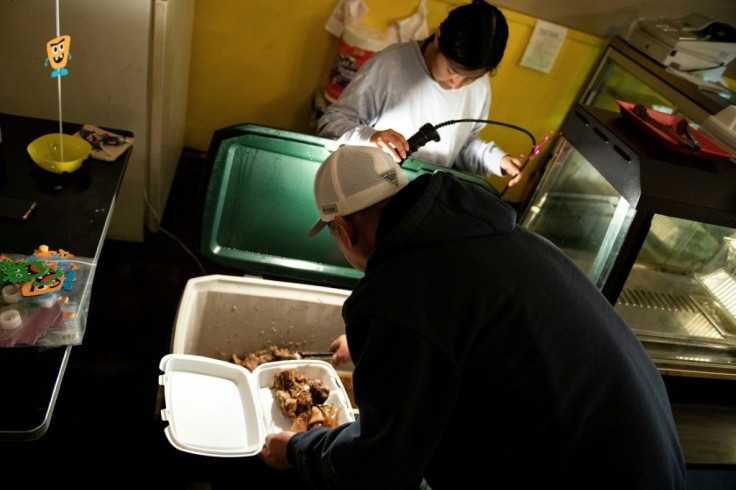 A man buys cooked hog meat at the Carnitas Nino restaurant in West Liberty, the first town in Iowa to become majority-Latino
