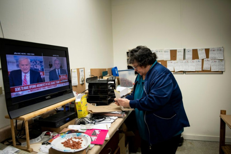 The news is seen on TV as Mary Wilson, owner of Ohio Medical Uniforms who purchased the business after retiring from occupational therapy, prepares a special order in Ashtabula, Ohio