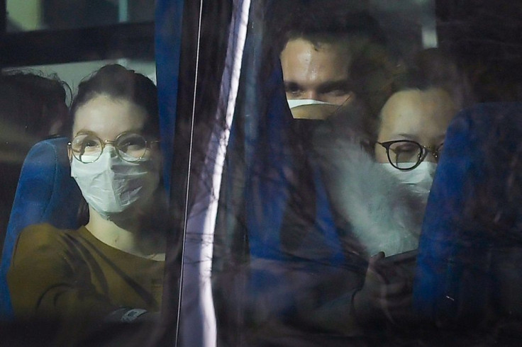 Passengers look on from a vehicle carrying French citizens evacuated from  Wuhan, China, near Marseille, France on January 31, 2020