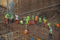 Ethiopian workers stand on scaffolding in 2015 during the construction of the Grand Renaissance Dam
