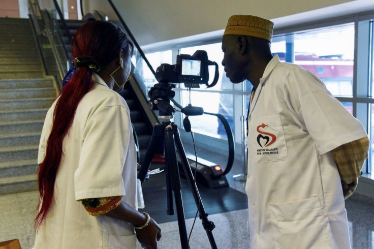 Health workers set up a thermal scanner to screen arriving passengers at Dakar's international airport