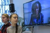 Greta Thunburg watches fellow eco warrior Vanessa Nakate, speaking from Kampala, after she was cropped out of a photo of young activists
