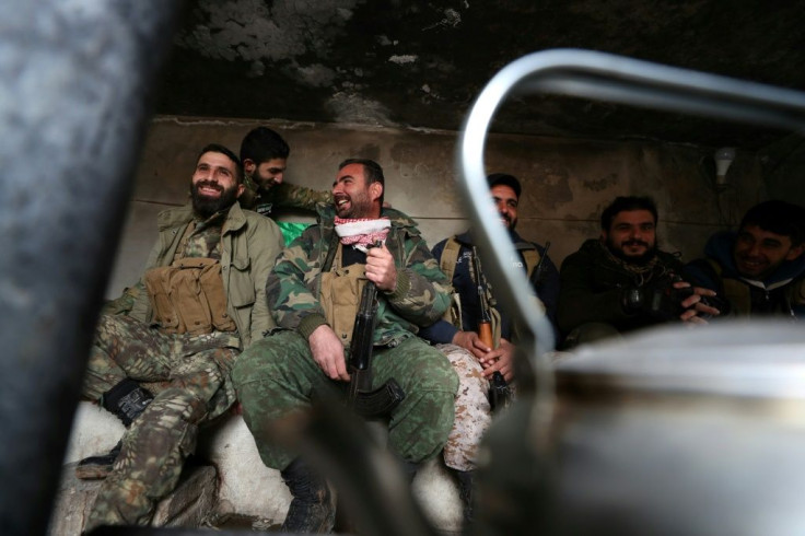Syrian rebel fighters rest inside a cement bunker in Saraqeb before returning to the front