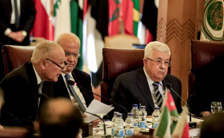 Palestinian president Mahmud Abbas (R) and Palestine Liberation Organisation Secretary-General Saeb Erekat (C) attended the extraordinary meeting of the Arab League held in Cairo on Saturday in response to the unveiling of the US peace plan
