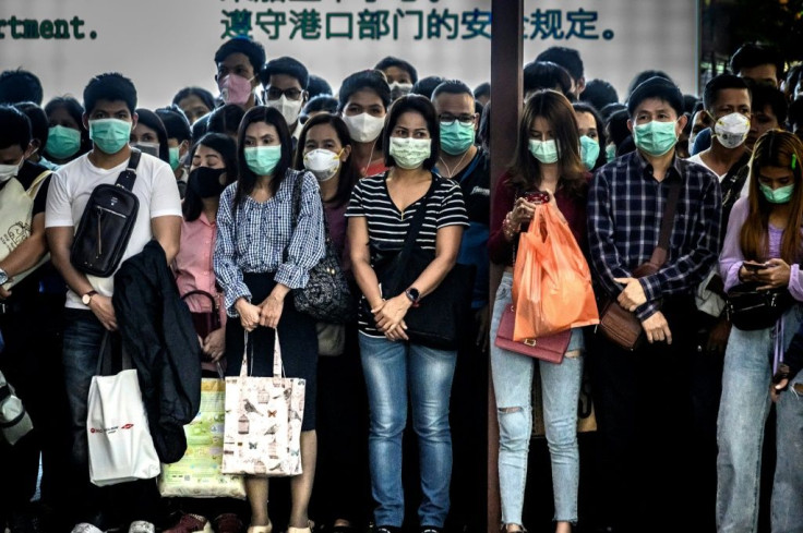 Commuters are shown in Bangkok wearing face masks, which are in short supply across all of Asia