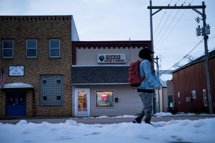 A man walks past the American Legion and the Acapulco Mexican Bakery in Iowa's first Hispanic-majority city of West Liberty