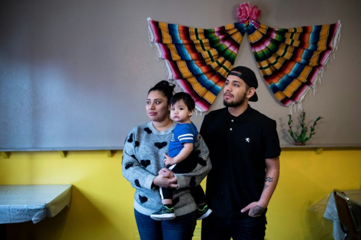 Roselia Ocampo and her husband Luis Ocampo pose with their son Sebastian at their Carnitas Nino restaurant in Iowa's first Hispanic-majority town of West Liberty