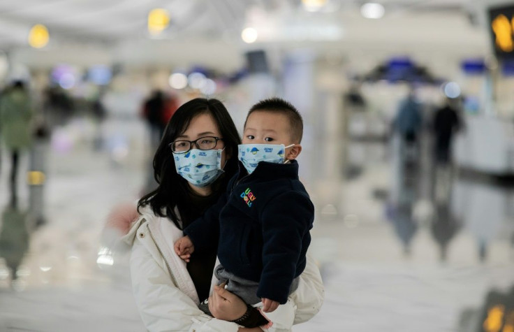 A woman and her child walk toward the check-in counter at Daxing international airport in Beijing