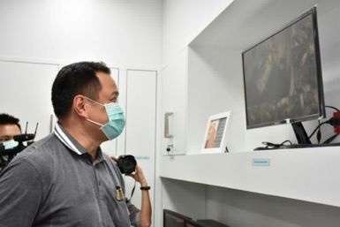 Health Minister Anutin Charnvirakul views closed circuit video images at Bamrasnaradura Infectious Disease Institute in Nonthaburi outside Bangkok where patients infected with the SARS-like virus are confined