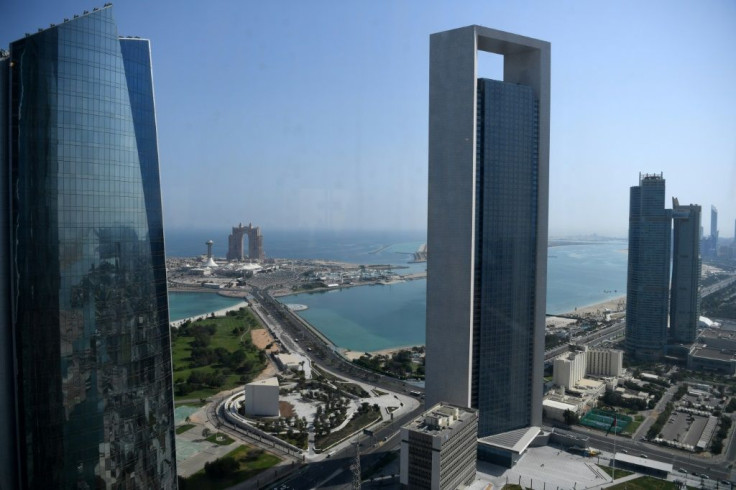 Sea front promenade in the Emirati capital Abu Dhabi with the ADNOC headquarters (Abu Dhabi National Oil Company) office complex (C) in the foreground