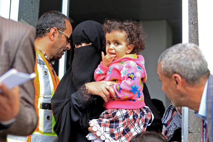 A sick Yemeni child is carried onto a UN plane at Sanaa airport for evacuation to Amman for urgent medical treatment