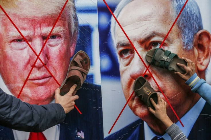 Palestinian protesters stick their footwear on posters depicting US President Donald Trump and Israeli Prime Minister Benjamin Netantyahu during a recent demonstration against Trump's Middle East peace proposal in the Gaza Strip