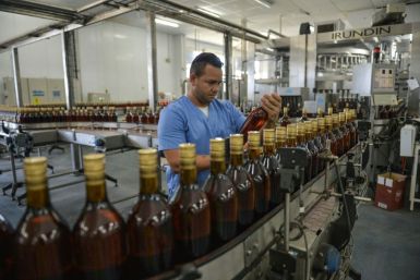 A worker checks bottles of rum at the Havana Club production plant in San Jose de las Lajas, Cuba
