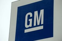 General Motors reported a fourth-quarter loss due to a lengthy labor strike in the United States, while projecting lower 2020 industrywide sales in the US and China
