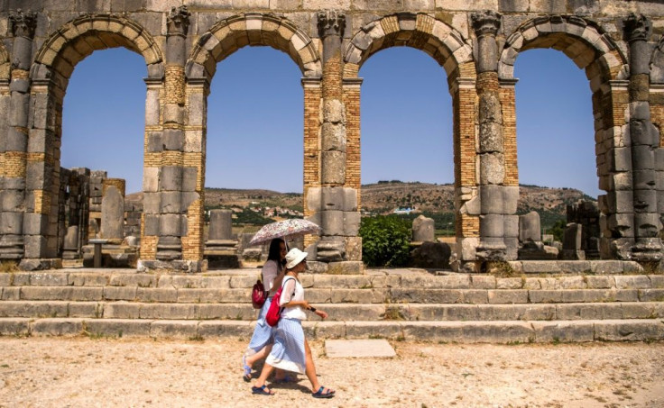 Tourists walk through the ruins of the ancient Roman site of Volubilis, near the Moroccan city of Meknes