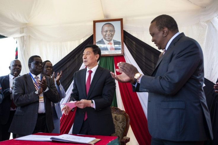 A Chinese special envoy, Wang Yong, signs the visitors' book at the Nairobi Terminus during the commissioning of the upgraded rail line in December 2019