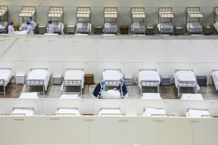 Medical staff set up beds for patients displaying mild symptoms of the coronavirus at an exhibition centre converted into a hospital in Wuhan in China