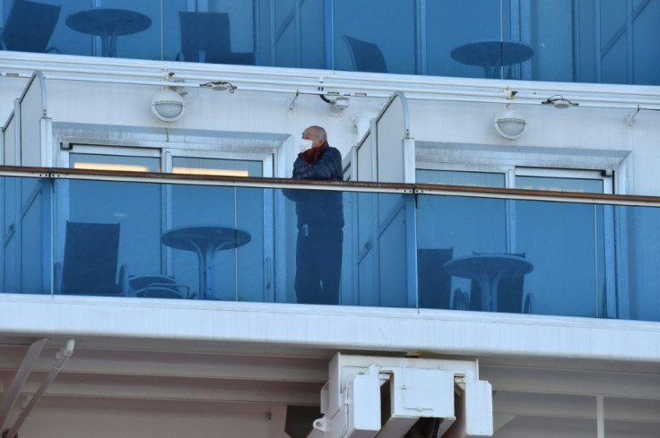 A passenger looks out from the balcony on the quarantined Diamond Princess cruise ship, carrying 3,700 people, in Yokohama, Japan