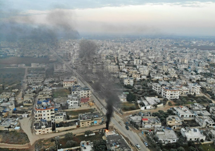 Smoke billows from tyres burnt by Syrians in an attempt to hinder air strikes in the town of Binnish in Idlib province