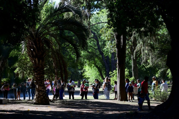 In Lomas de Zamora, on the outskirts of Buenos Aires, people queue up to collect their food card