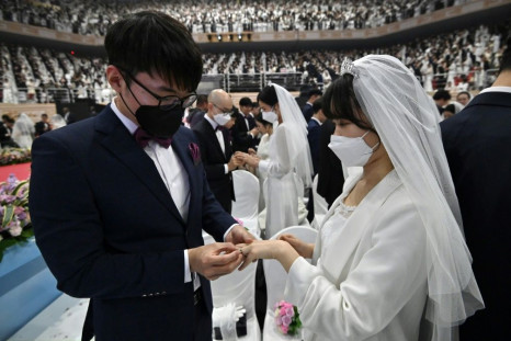 The church founded by Sun Myung Moon distributed face coverings to the 30,000 crowd, but only some donned them