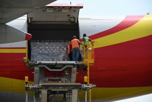 Workers unload supplies from an aircraft at Simon Bolivar International Airport outside Caracas in May 2019