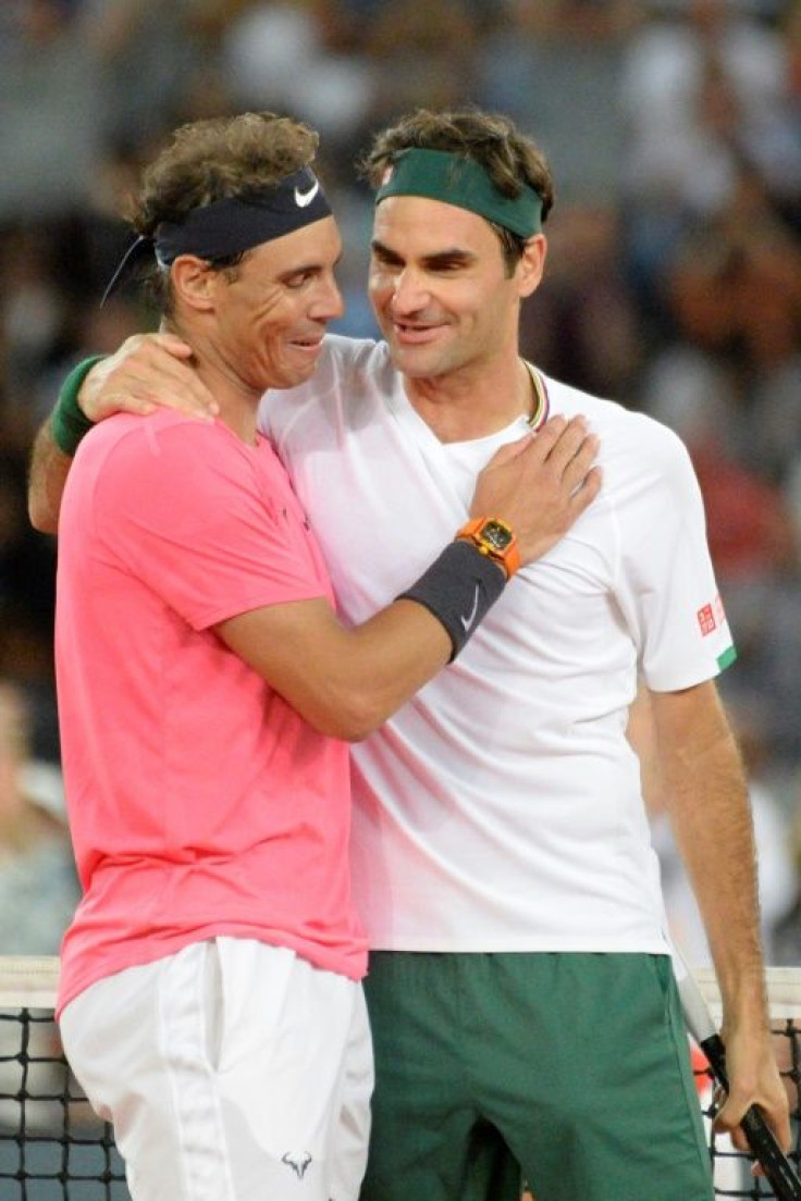 Old rivals: Nadal embraces Federer during their singles match