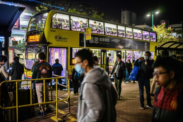 Buses shuttle travellers to checkpoints at the border between Hong Kong and mainland China