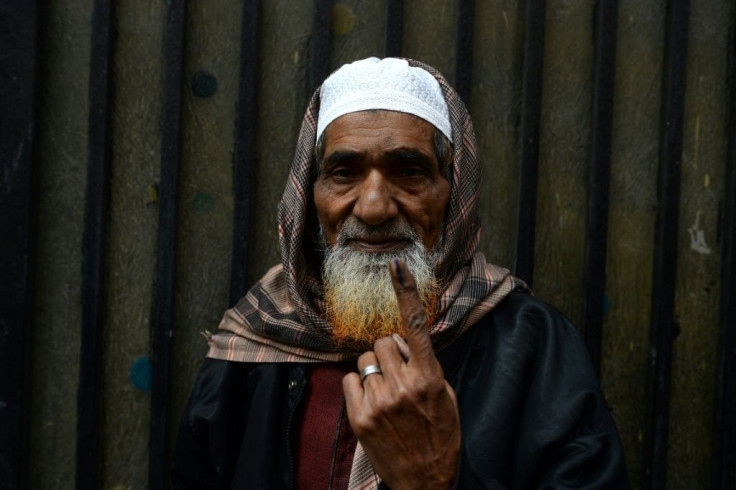 A man shows his ink-marked finger after casting his vote in Delhi elections on Saturday