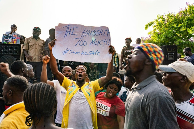 A protester holds a placard during a protest earlier this week against the deepening economic crisis