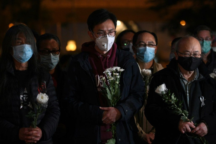 People attend a vigil in Hong Kong for dead Chinese doctor Li Wenliang, who tried to warn about the new coronavirus