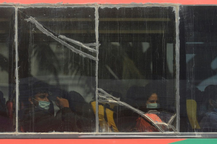 Bangladeshis evacuated on a first flight from Wuhan are taken by bus to quarantine