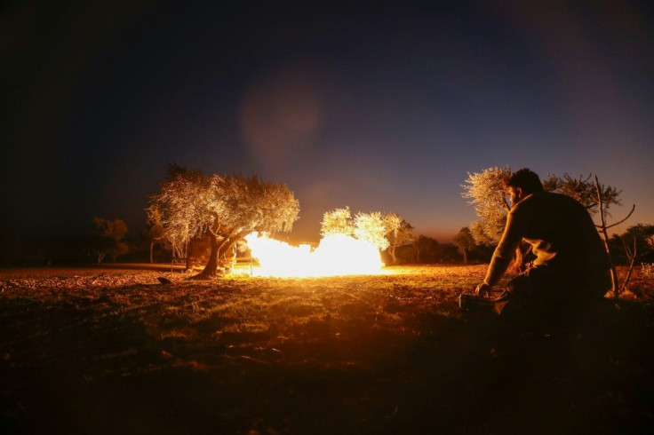 A Syrian rebel fires a rocket towards regime forces positions in the southern countryside of Aleppo