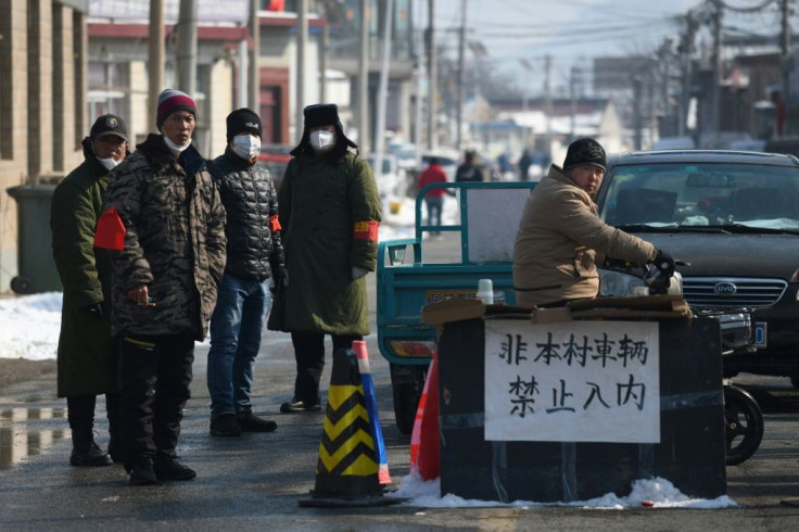Villages near Beijing have set up roadblocks to stop people entering their communities in the hope of keeping out the coronavirus