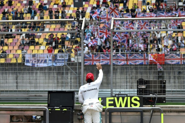Lewis Hamilton greets fans at the Chinese Grand Prix in Shanghai last year. This year's race could be under threat from the novel coronavirus