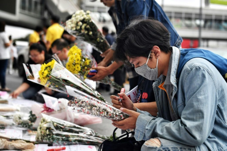 Mourners lay flowers at the Terminal 21 shopping mall, where a mass shooting took place, in the Thai northeastern city of Nakhon Ratchasima