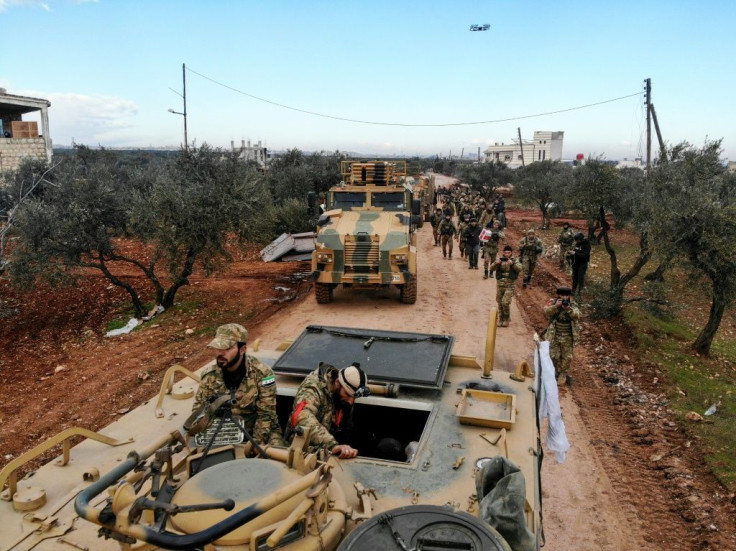 Turkish-backed Syrian fighters gather in the village of Qaminas, about 6 kilometres southeast of Idlib city on February 10, 2020