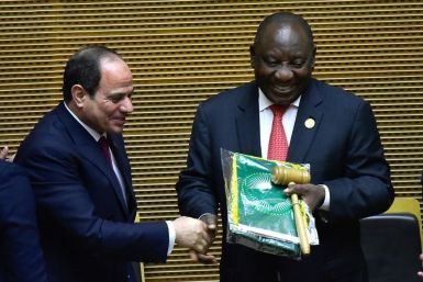 Handover: Outgoing AU chair Egyptian President Abdel Fattah al-Sisi, left, passes the baton to South African President Cyril Ramaphosa. Ramaphosa says settling the conflicts in Libya and South Sudan will be a priority of his tenure